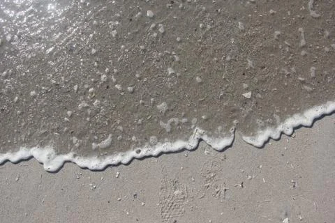 Wave soaking in the sand on a sandy beach Foto stock