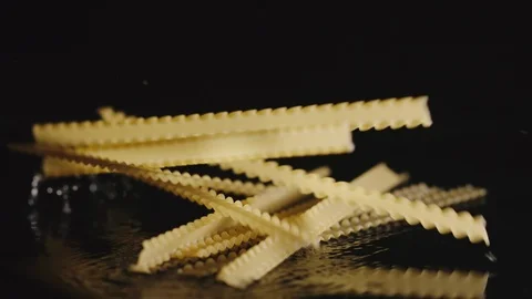 Wave spaghettis fall in water - Slow Motion Stock Footage 98384750