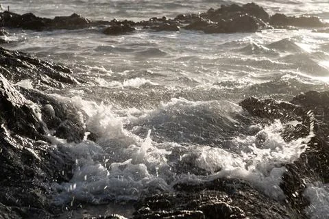 Wave splash against the light Stock Photos