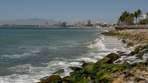 Wave splash Malecon Boardwalk Puerto Vallarta city in back ground-Slow motion Stock Footage 107007611