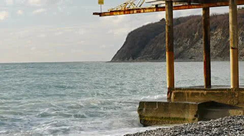 Wave splash at the pier in the evening light Background Stock Footage 10595017