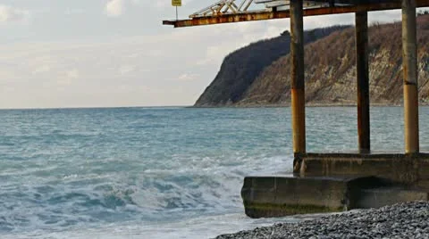 Wave splash at the pier in the evening shadow Background Stock Footage 10595015