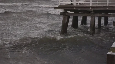 Wave splash at the pier on a stormy day Stock Footage 69754067