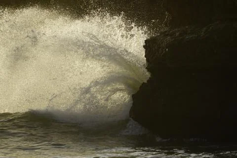 Wave splash on a rock Stock Photos