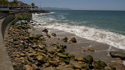 Wave splash on rocks at Malecon Boardwalk Puerto Vallarta-SloMotion Video stock 107005742