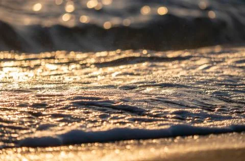 Wave splash sea beach close up sunrise Stock Photos