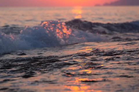 Wave splash at sunset Stock Photos