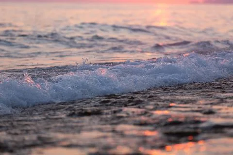 Wave splash at sunset Stock Photos