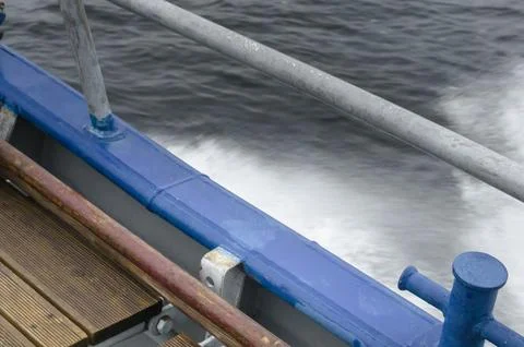 Wave splashes behind the boat Photos