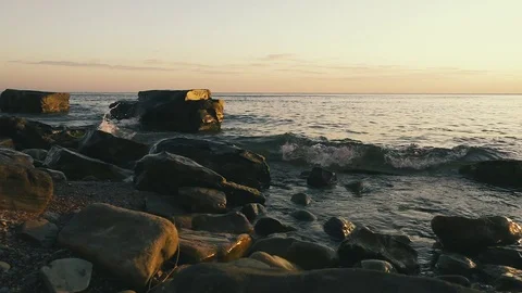 The wave with splashes breaks down on the rocks slow motion Stock Footage 81404394