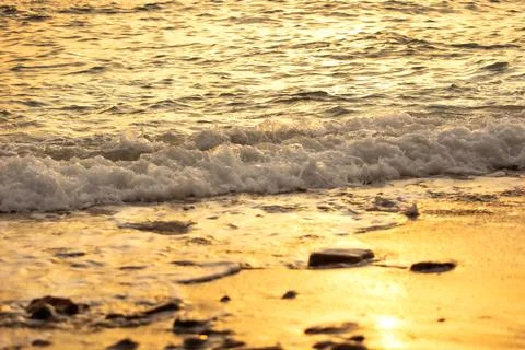 Wave splashes close-up, sunset sea background Stock Photos