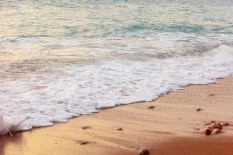 Wave splashes close-up, sunset sea background Stock Photos