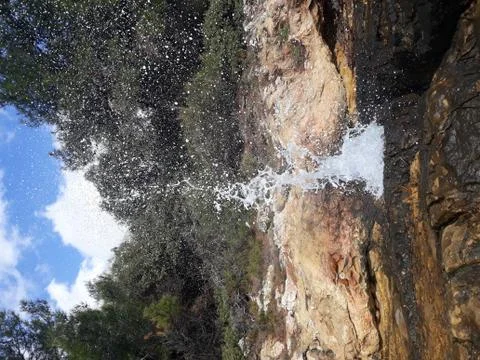 Wave Splashes over Rocks Stock Photos