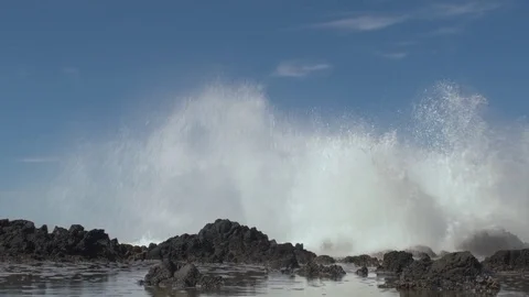 Wave splashes on rocks dramatically up in the air Stock Footage 80549392