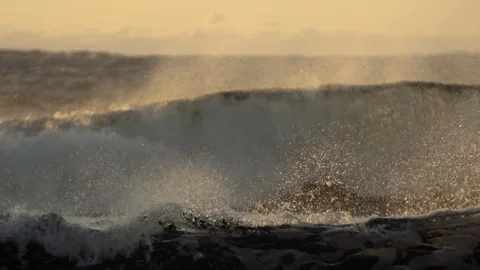 Wave splashes water drops at sunset, slow motion Video stock 94681652