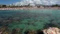 Wave splashing about rocks with Coral Bay beach on background, Paphos, Cyprus HD Footage