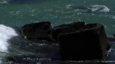 Wave splashing against rocks Stock Footage 21693239