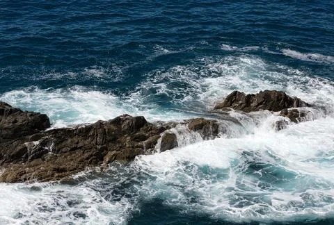Wave splashing over a rock on Caleta Negra beach in Ajuy  on Fuerteventura. Stock Photos