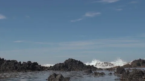 Wave splashing on rocks dramatically up in the air Stock Footage 80547291