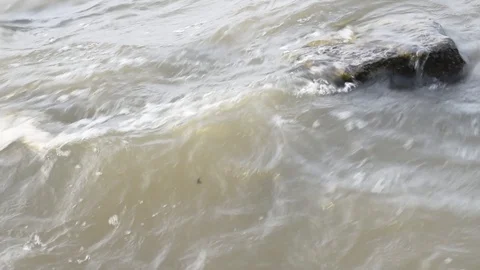 Wave splashing rocks Stock Footage 129209557