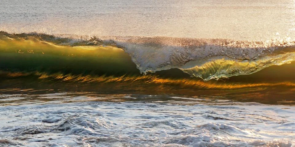 Wave at sunset Stock Photos