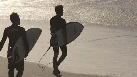 Wave Surfers enter the water Stock Footage 71024197
