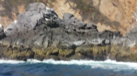 Wave swells over rocks 1 Stock Footage 7753653