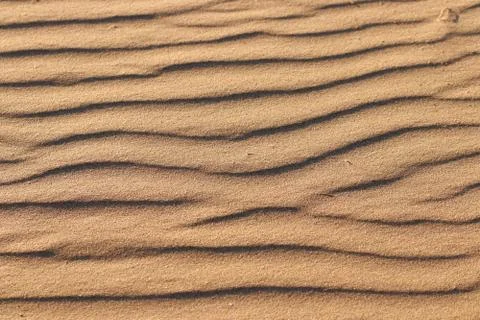 Wave texture on sand beach Photos