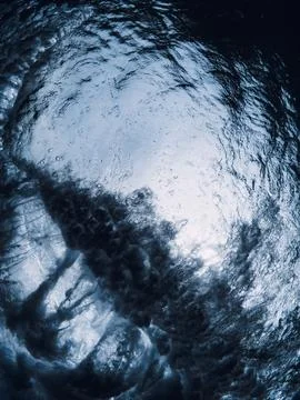 Wave textures with vortex underwater in transparent sea water. Swell in ocean Stock Photos