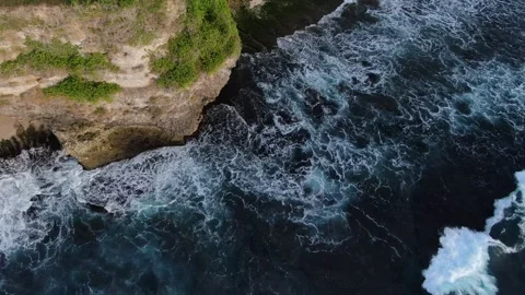 Wave towards Uluwatu cliffs drone shot Stock Footage 303572500