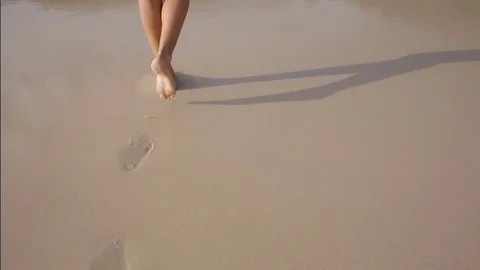 Wave washes away the footprints Stock Footage 80014414