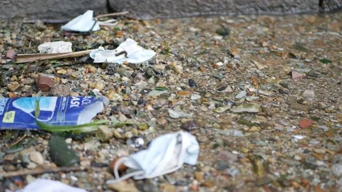 Wave washes up COVID Facemasks. Stock Footage 152956932