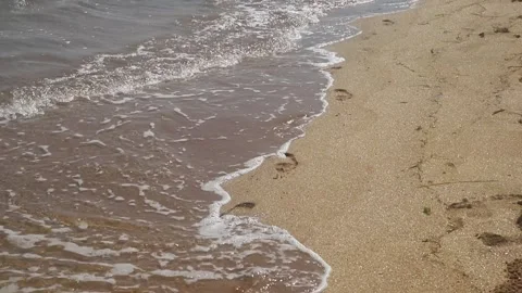Wave Washes Footprints In The Sand Stock Footage 136519956
