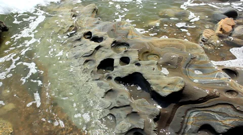 Wave Washes over Pitted Rock Vídeo Stock 38673586