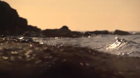 A wave washes over rocks closeup. Slow motion. Stock Footage 53146681