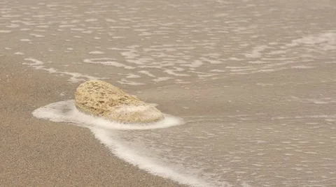 Wave washes stone. Slow motion. Stock Footage 52422117
