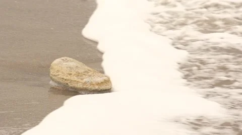 Wave washes stone. Slow motion. Stock Footage 52422159