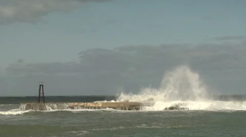 Wave washing down seawall Stock Footage 8509735