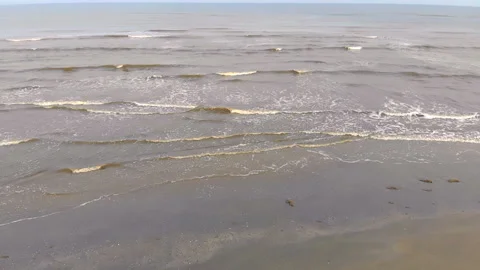 Wave of waves come to the shore slow motion. The seagull flies over the waves Stock Footage 97353558
