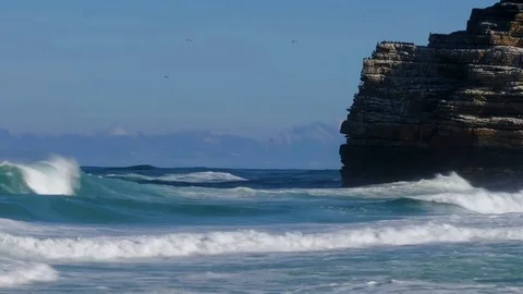 WAVE, WAVES, huge sea waves against the blue sky and dark clouds on the hori Stock Footage 123969398