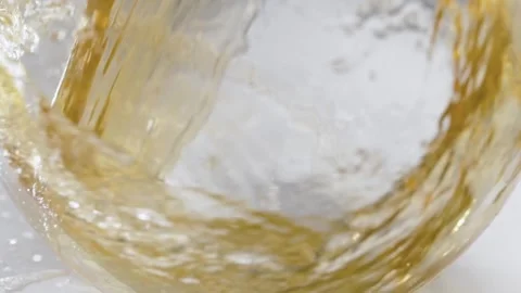 Wave of white dry wine or fruit juice in a clear vessel in slow motion Vídeos de archivo 268745263