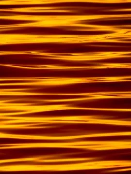 Wavelets on the surface of sunset lake Stock Photos