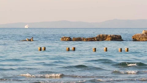 Waves on the adriatic sea, beach of bacvice in split, croatia. Stone pillars  Stock Footage 129110399
