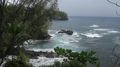 Waves against cliff on cloudy day Stock Footage 53429767