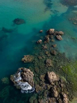 Waves against Sharp rocks formation in turquoise sea in Malta aerial Stock Photos