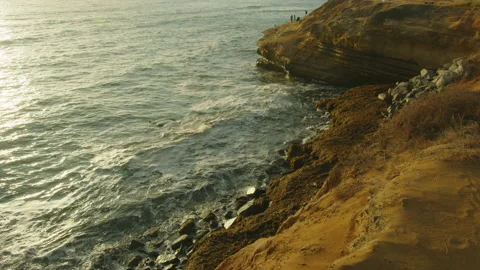 Waves against sunset cliffs Video stock 188926210