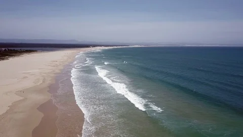 Waves along the beach on calm sunny day Video stock 71613273