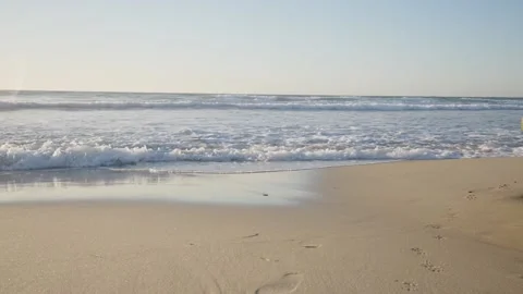Waves along the shoreline of a sand beach Stock Footage 172564534