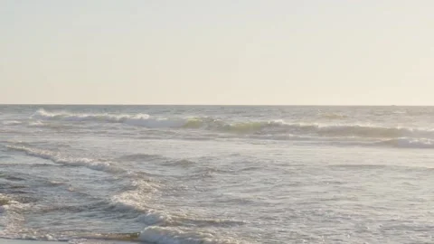 Waves along a sunset shoreline Stock Footage 172564487