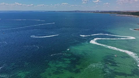 Waves and boats create patterns on a clear ocean at midday in summer Stock Footage 339652768